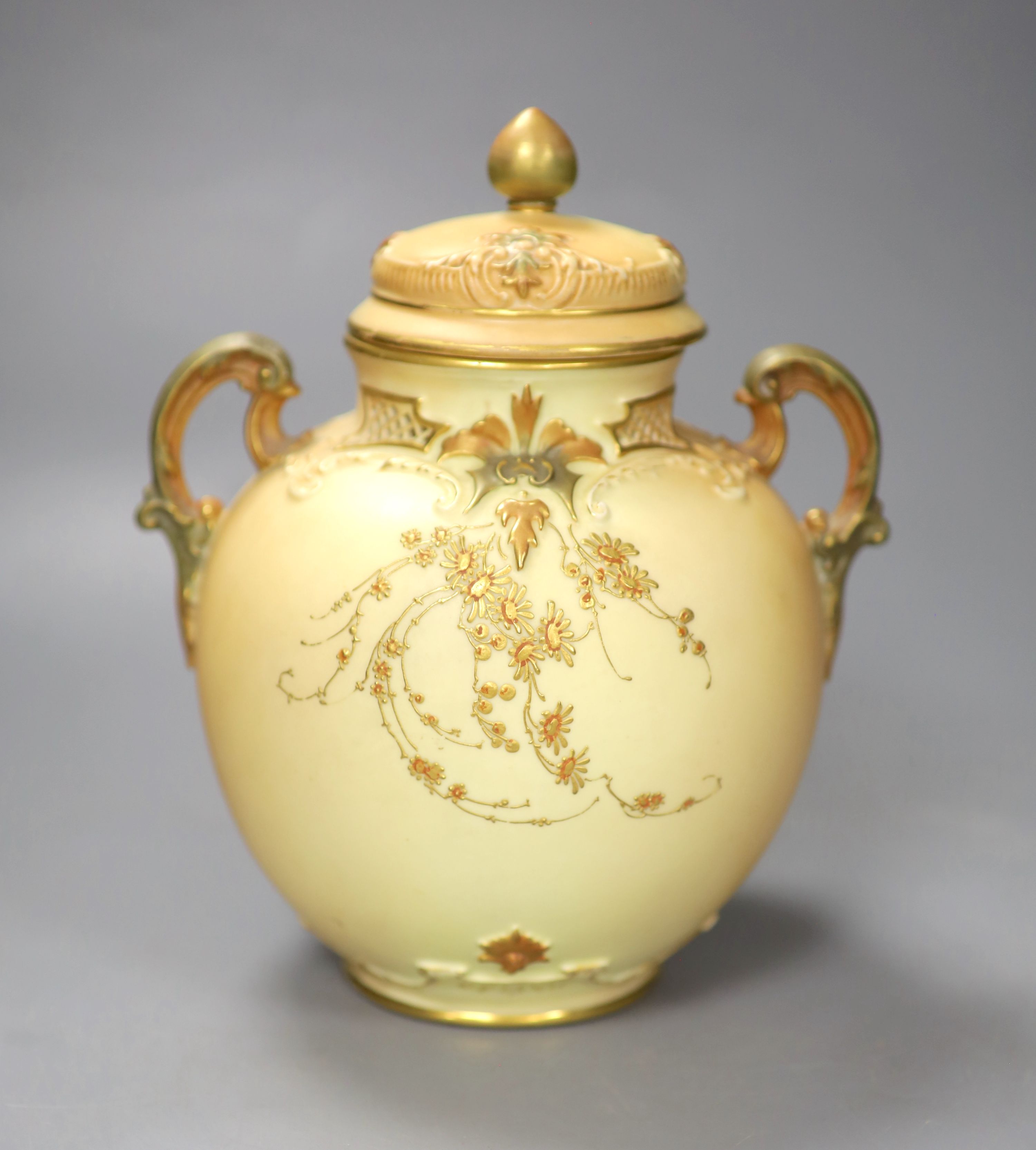 A Royal Worcester two handled ovoid vase moulded and gilded with flowers on a blush ivory ground, shape 1515 date code for 1896, 20cm h